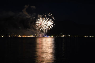 Low angle view of firework display at night