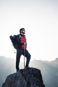 Full length of man standing on rock against mountain