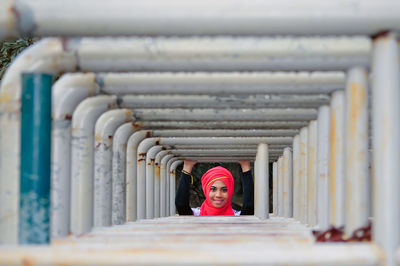 Rear view of woman standing against wall