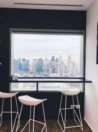 Chairs and table by window in city