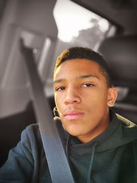 Portrait of young man sitting outdoors