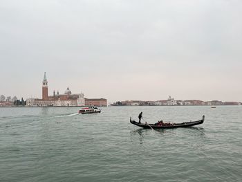 Boats in sea against sky