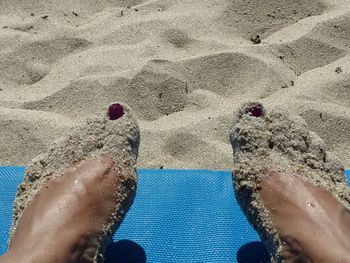 Low section of legs on sand