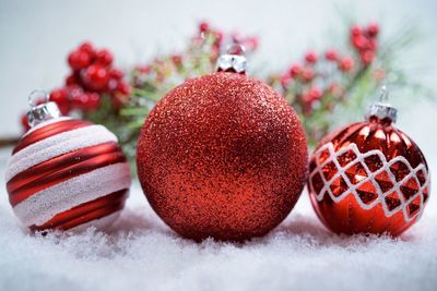 Close-up of christmas decorations on snow