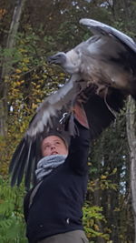 Midsection of man feeding bird