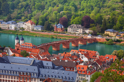 High angle view of townscape by river against buildings