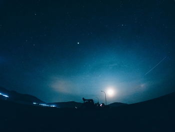 Low angle view of silhouette stars against sky at night