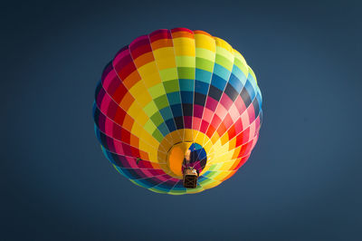 Low angle view of person paragliding against clear sky