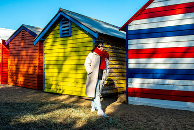 Rear view of man standing against building