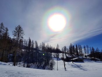 Scenic view of snow covered land against sky