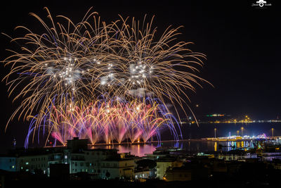 Low angle view of firework display at night