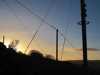 Close-up of silhouette against sky at sunset