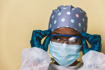 Doctor wearing mask against blue background