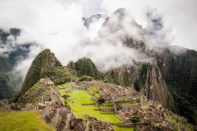 Scenic view of mountains against cloudy sky