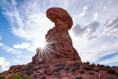 Dramatic desert landscape with amazing rock formation with sun burst.