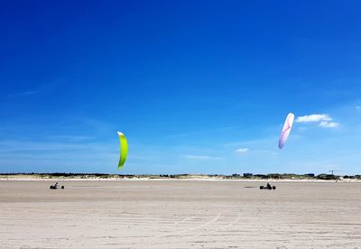 Umbrella on beach against blue sky