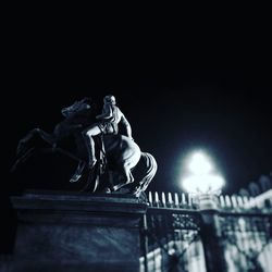 Low angle view of statue against clear sky at night