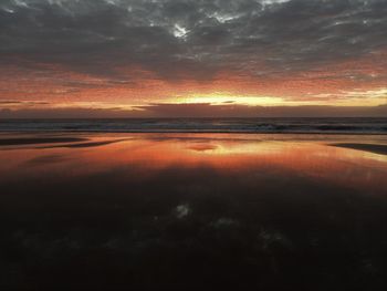 Scenic view of sea against romantic sky at sunset