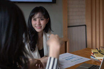 Portrait of a beautiful young woman with text on table