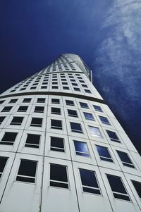 Low angle view of turning torso against sky