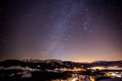 Scenic view of landscape against star field