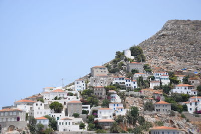 Buildings in town against clear blue sky