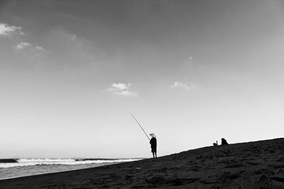 Man on beach against sky