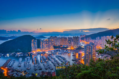 High angle view of illuminated city buildings against sky