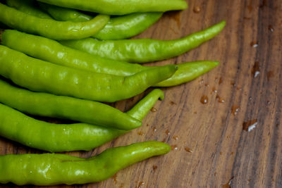 High angle view of green chili peppers on table