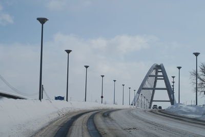 Street by road against sky during winter