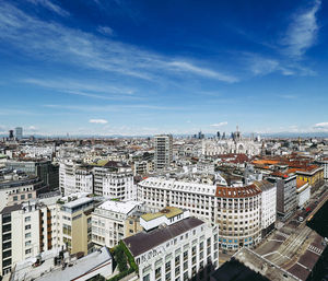 Aerial view of cityscape against sky during sunny day