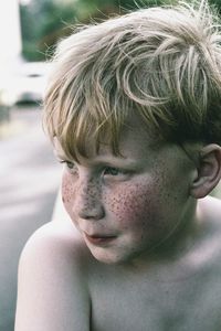 Close-up of boy with freckles on face