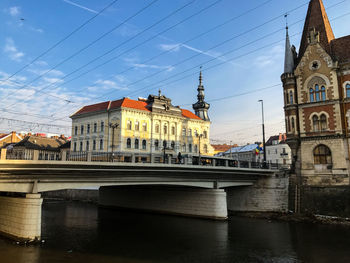 Bridge over river against buildings in city