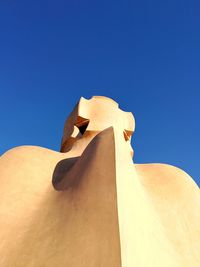 Low angle view of statue against clear blue sky