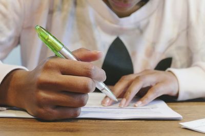 Cropped image of hand holding paper