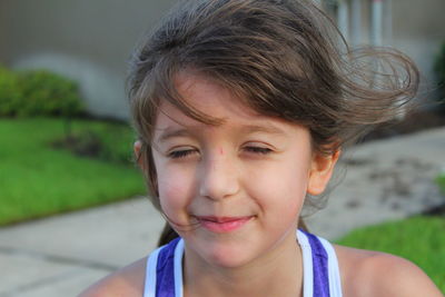 Close-up of girl with eyes closed smiling outdoors