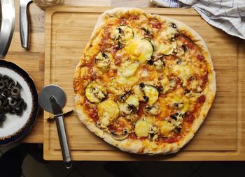 High angle view of pizza on cutting board