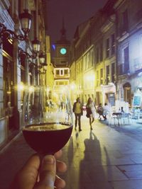People standing in illuminated city at night