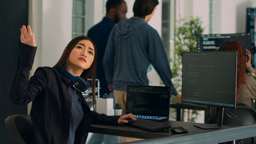 Side view of businesswoman working at office