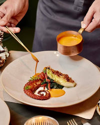 Midsection of man having food on table
