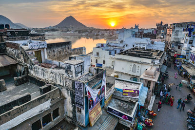 High angle view of buildings in city during sunset