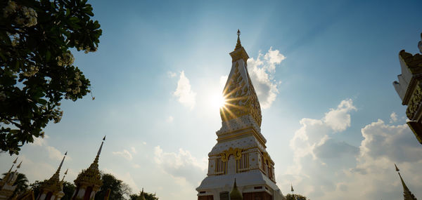 The pagoda of wat phra that panom temple in nakhon phanom in cloudy blue sky day with sunlight