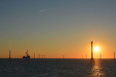 Scenic view of sea against clear sky during sunset