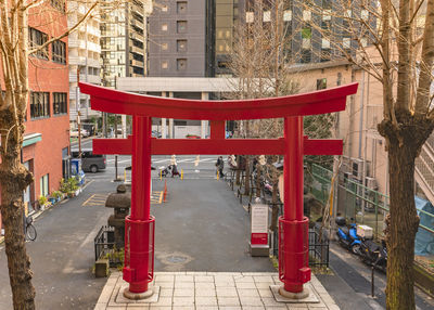 Red road amidst buildings in city