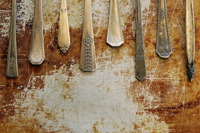 Close-up of spoons on old table