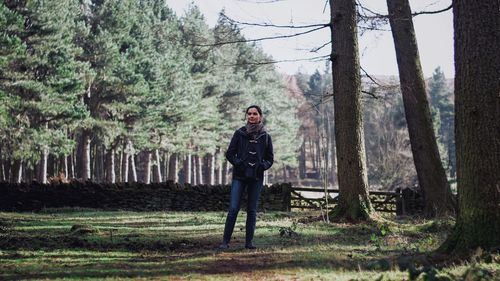 Full length portrait of man standing on tree