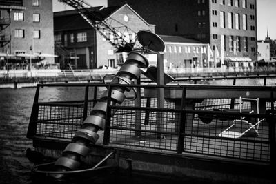 Low angle view of staircase in canal against buildings in city