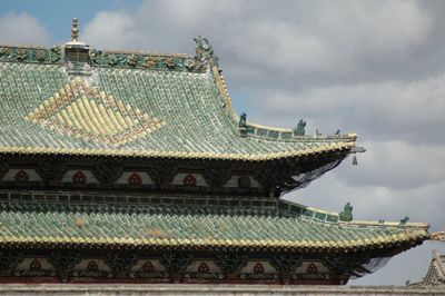 Low angle view of building against cloudy sky