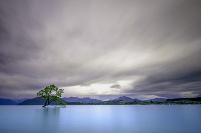 Scenic view of sea against cloudy sky