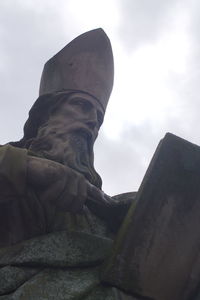 Low angle view of statue against sky